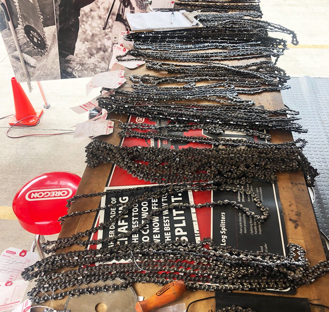 Saw chains laid out on a table
