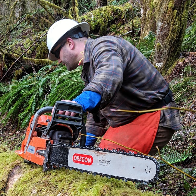 Nathan Frechen with his chainsaw which is equipped with Oregon bar and chain